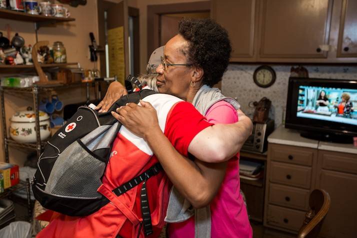 Woman hugs Red Cross volunteer